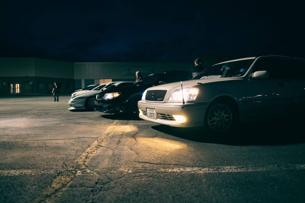 cars parked at night meet